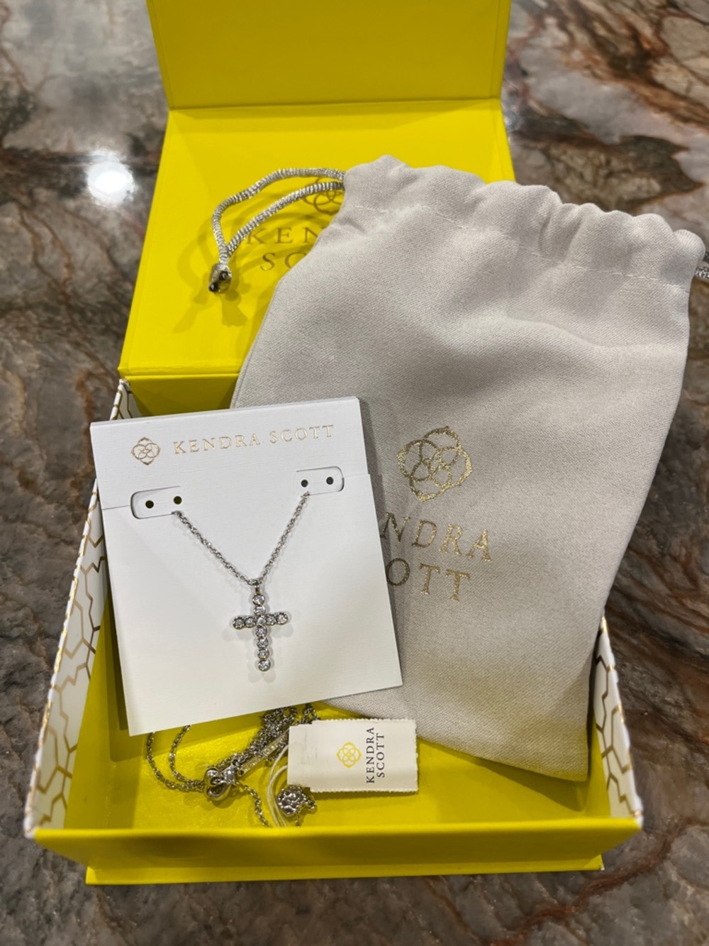 Kendra Scott Silver Crystal Cross Necklace with Gray Pouch and Yellow Box
